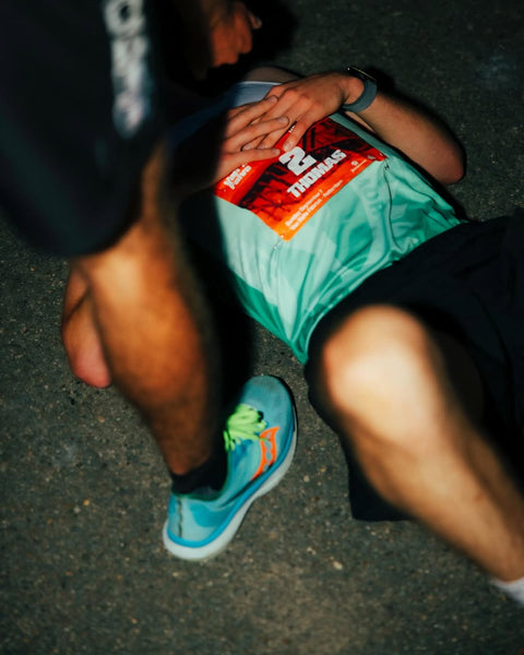Exhausted runner on the ground after the finish