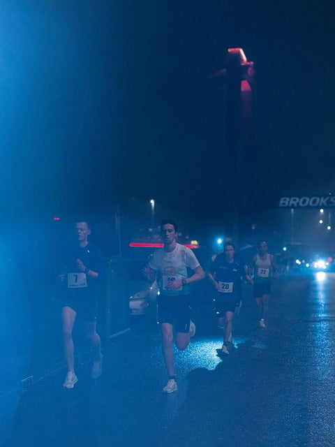 Runners in the mist at night